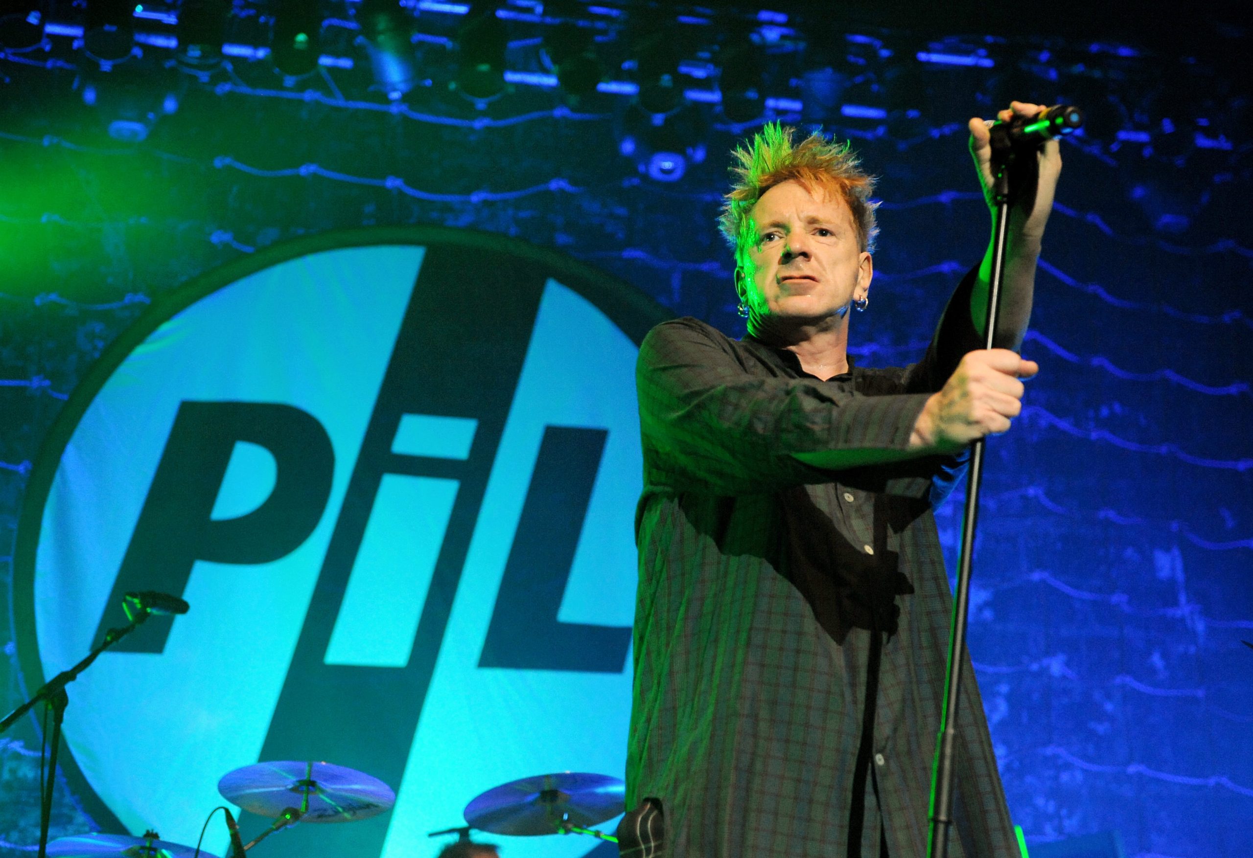 Picture By: Duncan Bryceland  - Picture shows John Lydon performing with Public Image Ltd (PIL) on the third night of their seven date reunion tour at the O2 Academy, Glasgow, Scotland, UK 18th December 2009. Singer John Lydon was formerly known as Johnny Rotton and was the frontman for the notorious English Punk band the Sex Pistols who produced an array of infamous songs such as 'God Save The Queen', 'Anarchy In the UK', 'Holiday In The Sun' and 'Pretty Vacant'.The shows mark the 30th Anniversary of the release of PIL's groundbreaking 'Metal Box' album and the gig showcased their whole career including their eponymous seminal single 'Public Image', 'Flowers of Romance', '(This is Not a) Love Song' and 'Rise'.