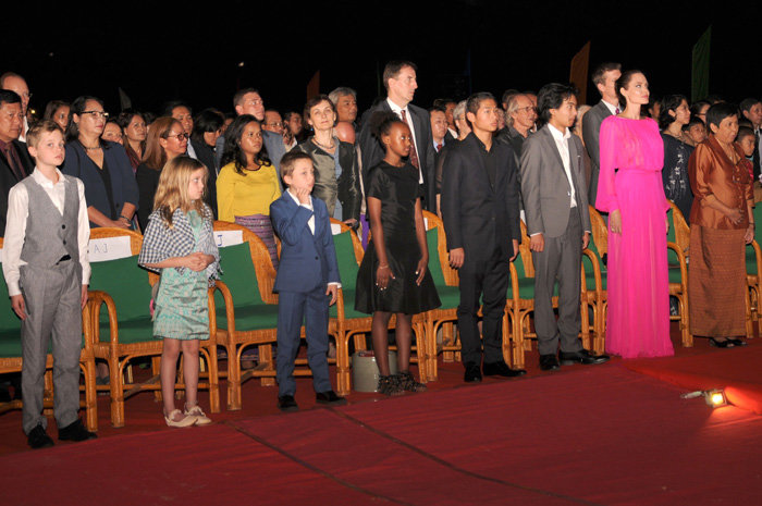 Cambodian Minister of Culture and Fine Arts Phoeung Sackona (Front R), Hollywood star Angelina Jolie (2nd-R) and her children listen to Cambodian national anthem during the the premiere of Jolie's new film 